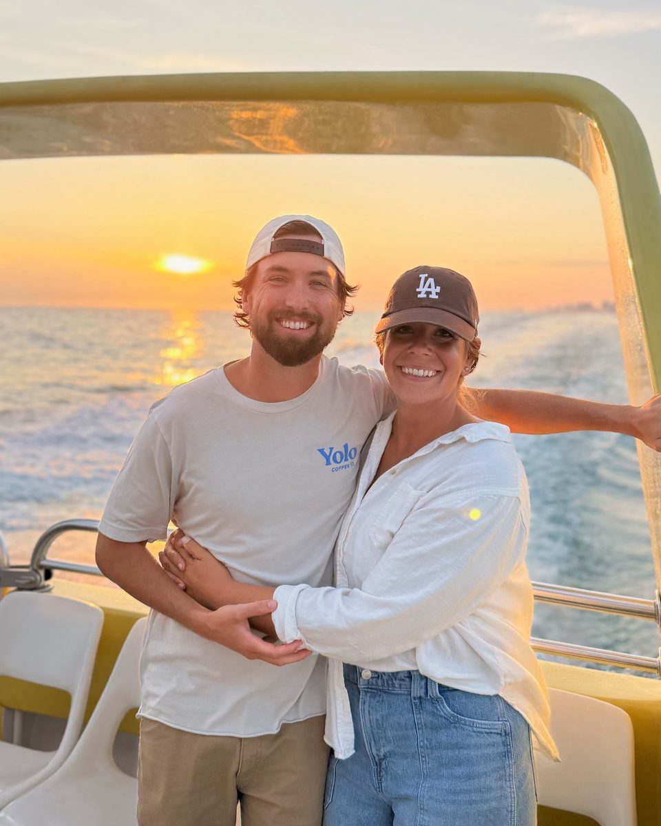 Cole, founder of Clarity Haus, with his wife on a boat at sunset